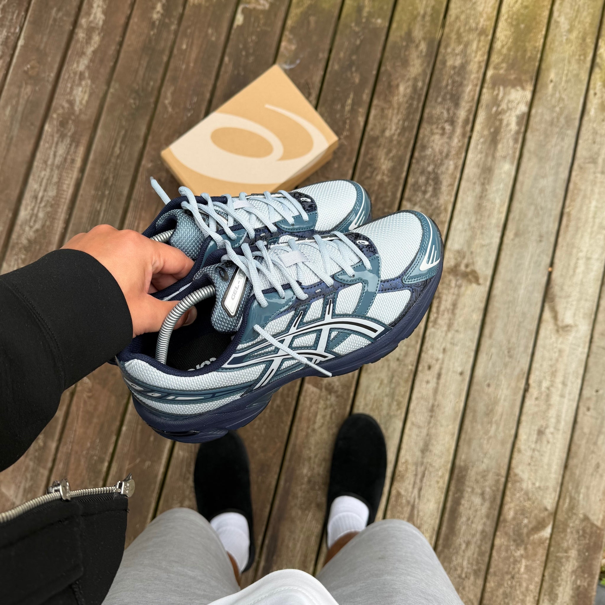 ASICS Gel-1130 Piedmont Blue trainer held in hand