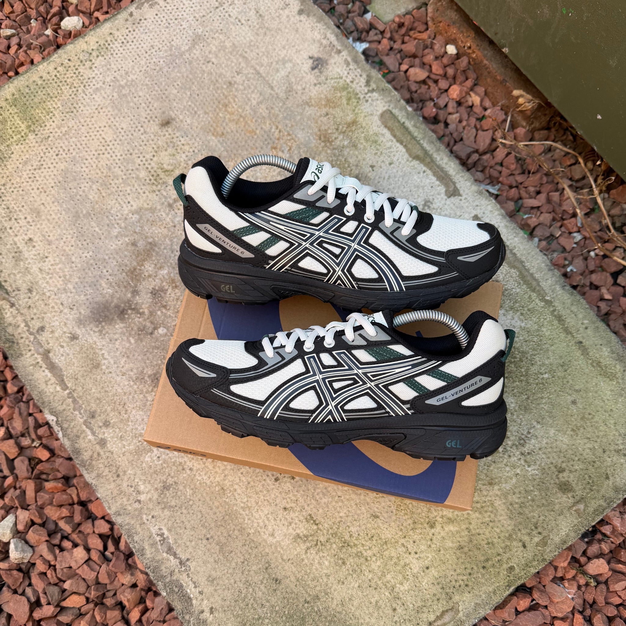 Pair of grey and white ASICS Gel-Venture 6 trainers