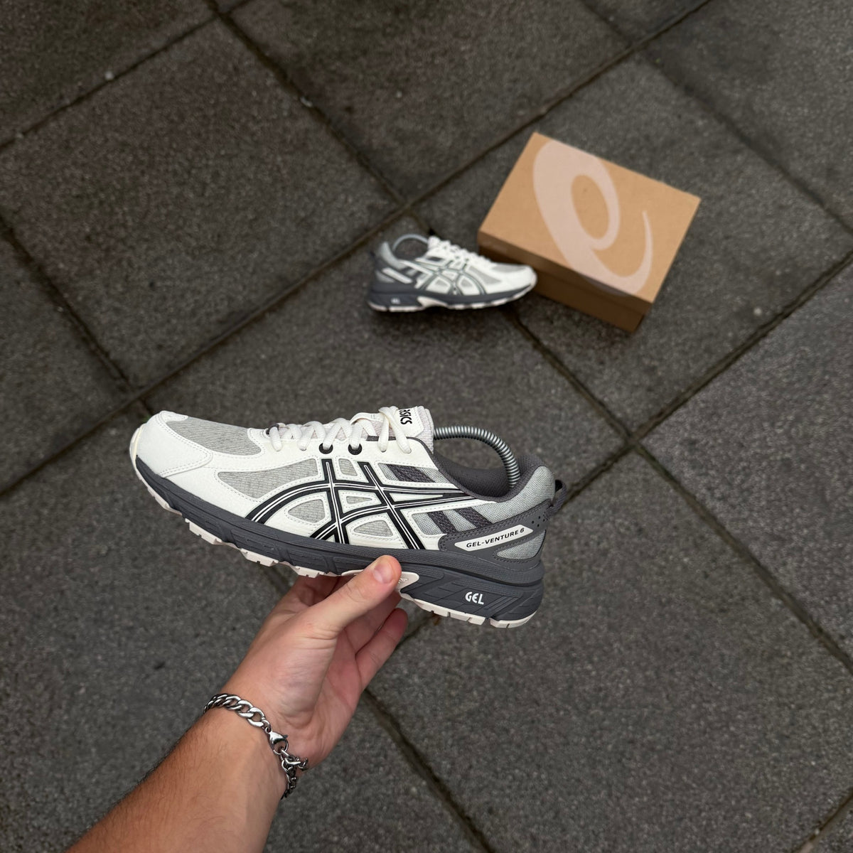 ASICS Gel-Venture 6 Olive Grey Cream trainer photographed at an angle highlighting contrasting cream and grey panels