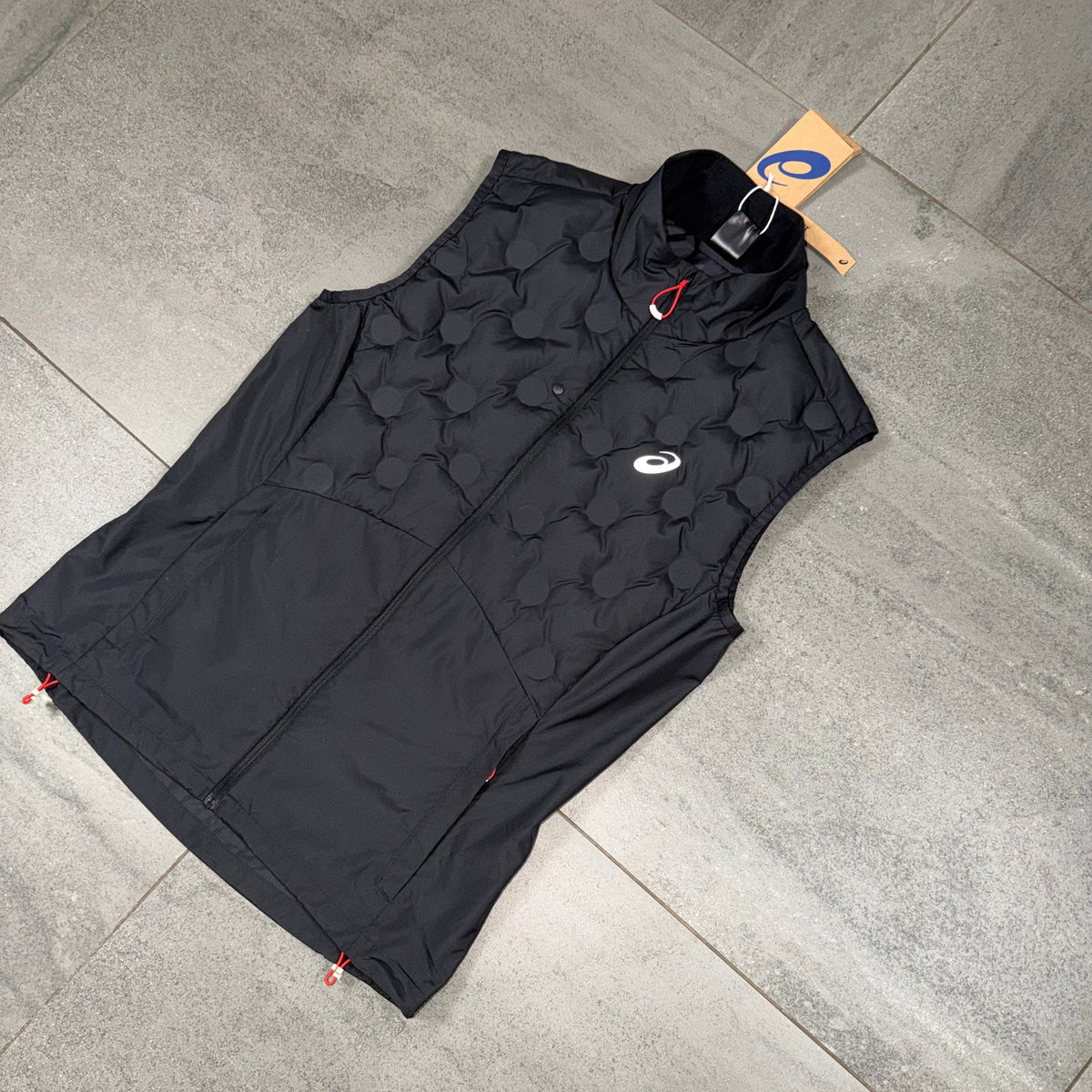 Black ASICS Run Gilet showing the quilted upper panels, ASICS branding and technical running design