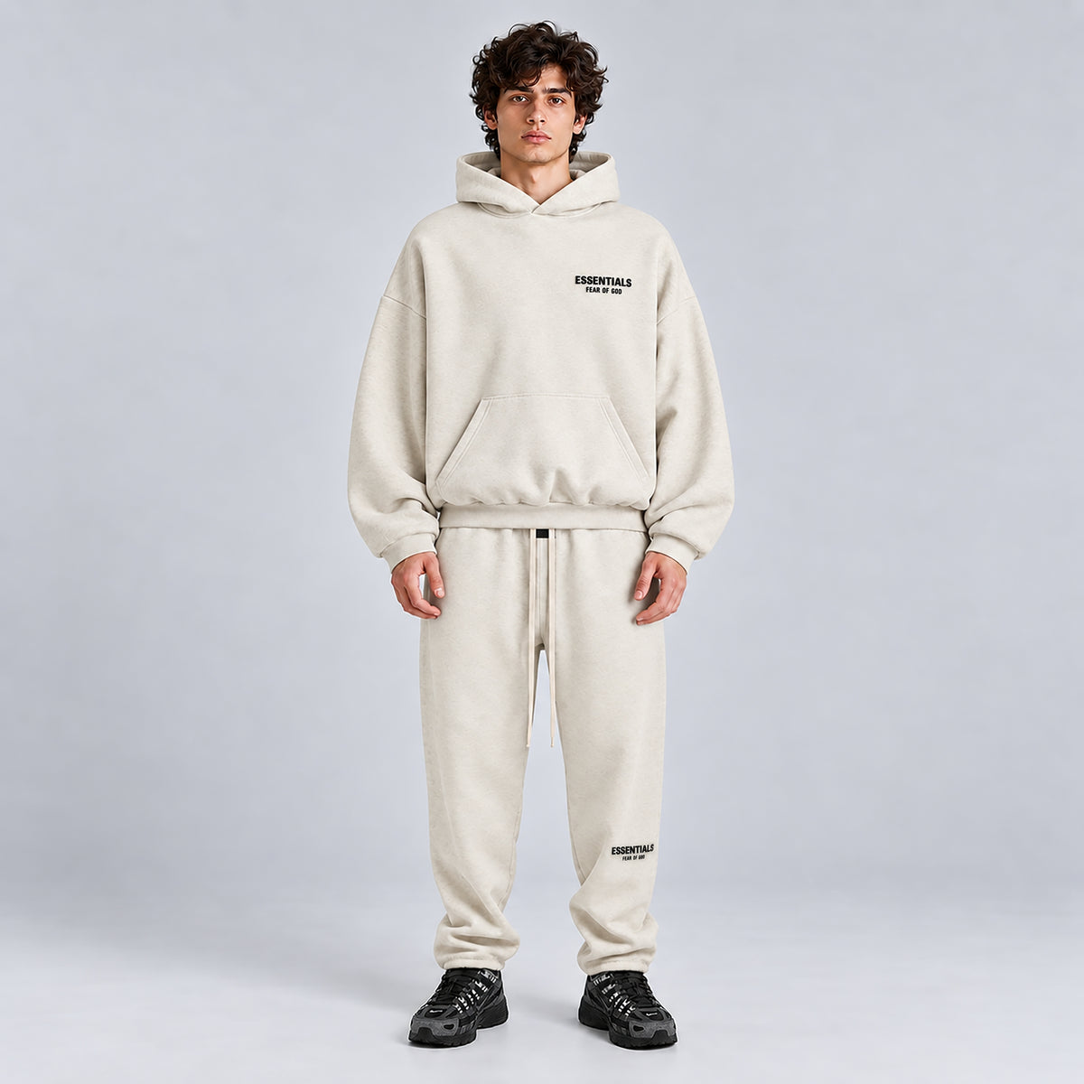 Fear of God Essentials Light Heather Oatmeal SS22 hoodie styled with matching sweatpants