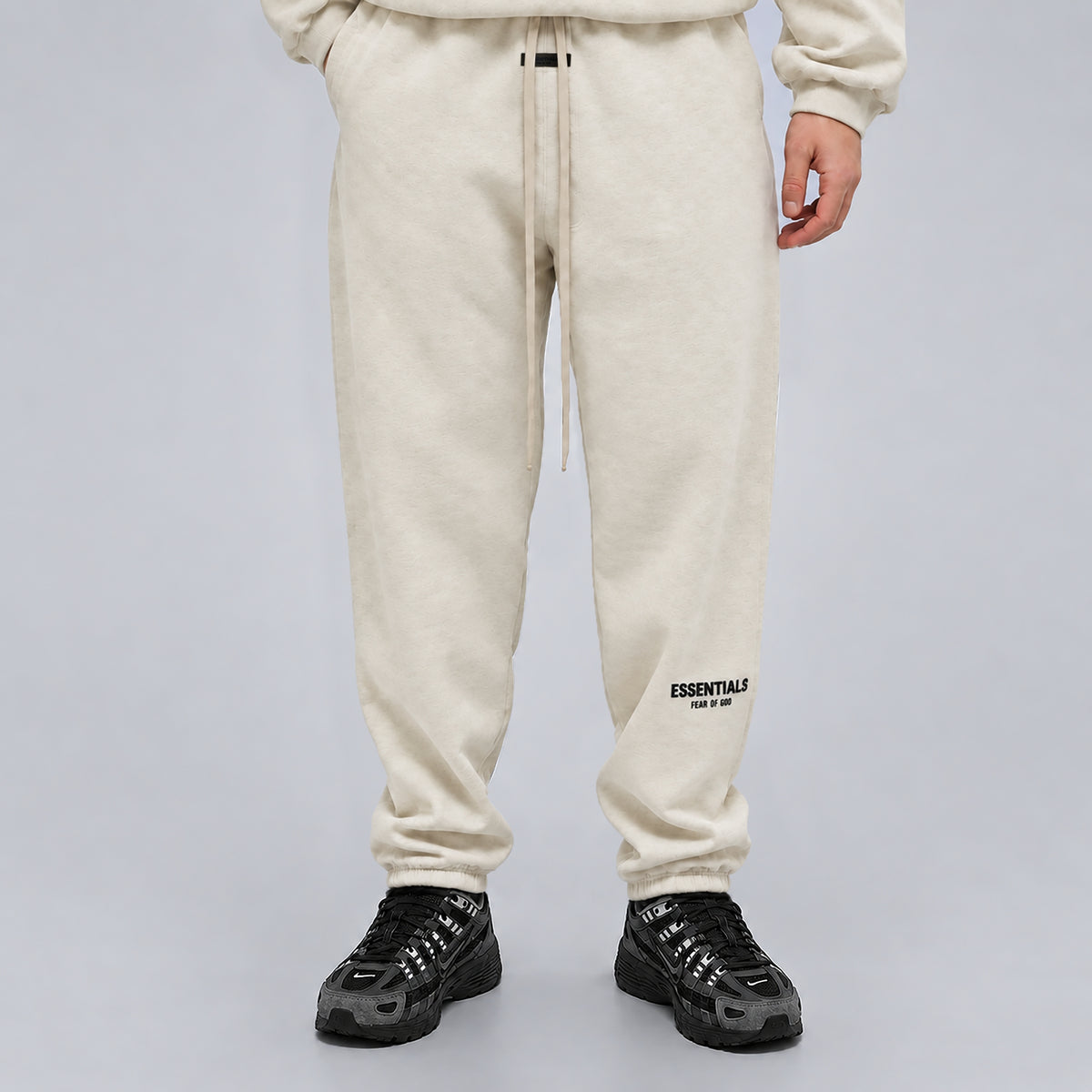 Front view of Fear of God Essentials Light Heather Oatmeal SS22 sweatpants