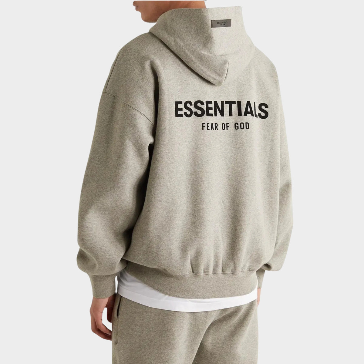 Rear view of Fear of God Essentials Dark Heather Oatmeal Hoodie showing large ESSENTIALS back branding