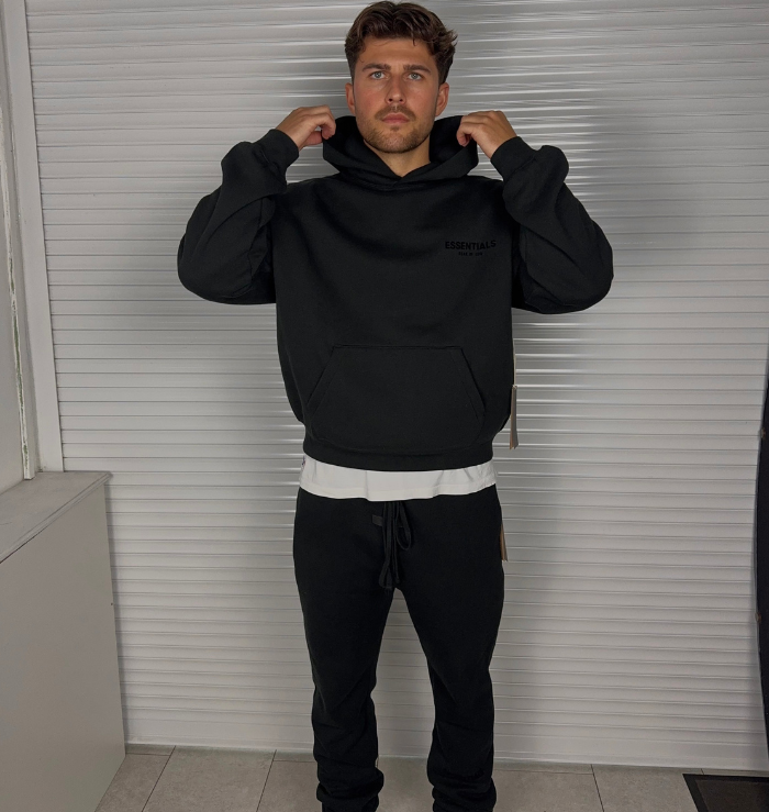 Fear of God Essentials Hoodie Black SS22 worn on body showing the relaxed fit and hood construction