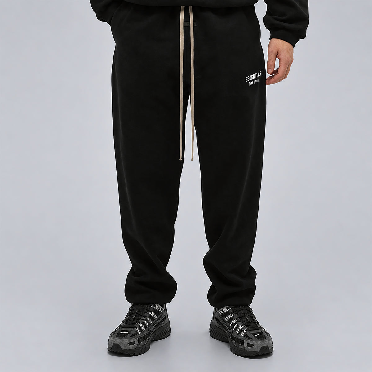 Fear of God Essentials Black Sweatpants FW24 worn from the front showing the relaxed leg fit