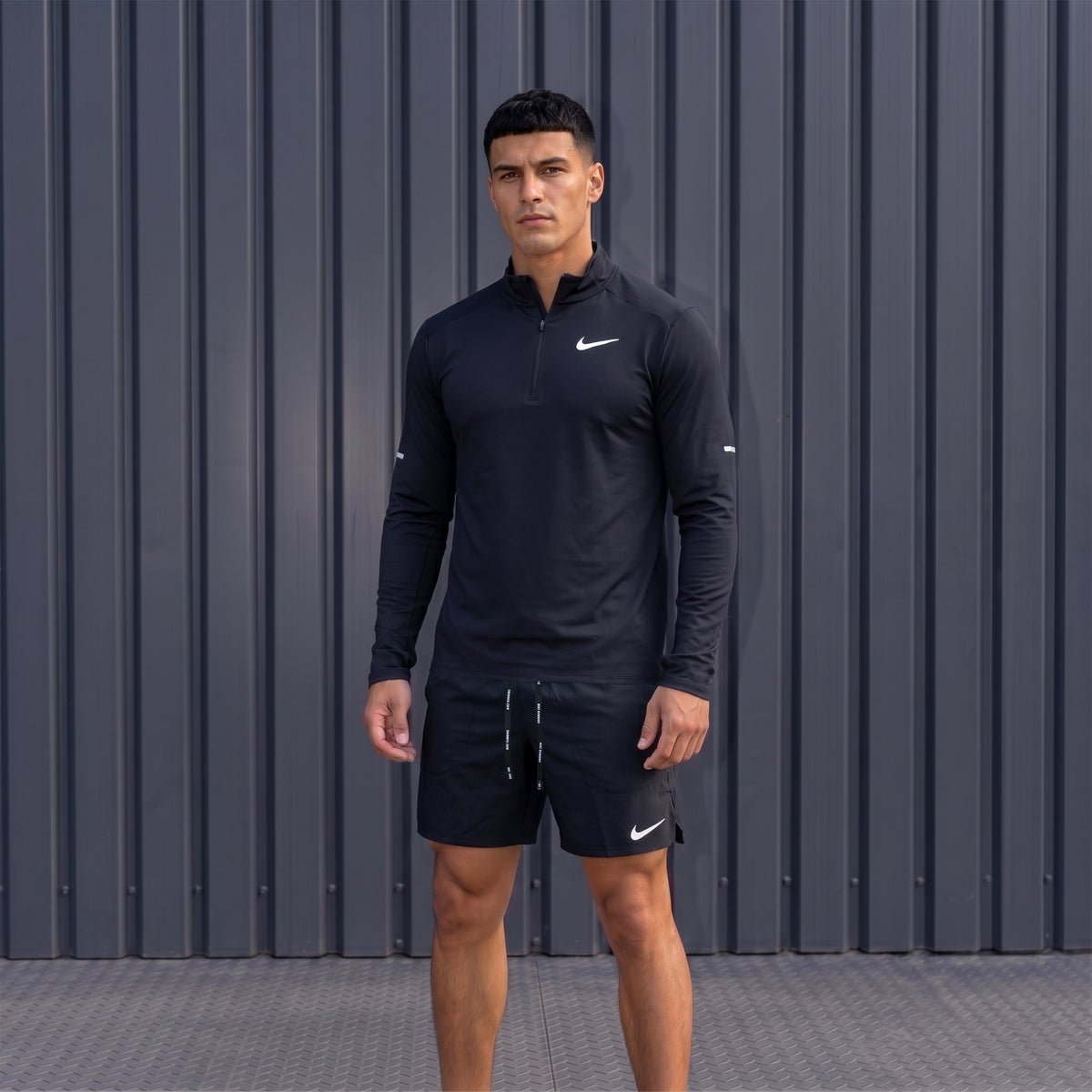 Nike black 1/4 Running Top and Flex Shorts worn by model front view