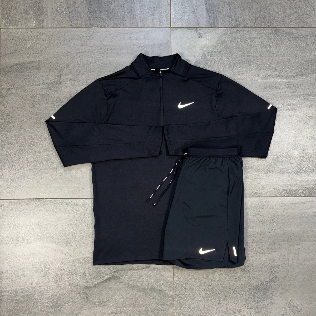 Nike Element Black 1/4 Running Top and Flex Shorts flat lay