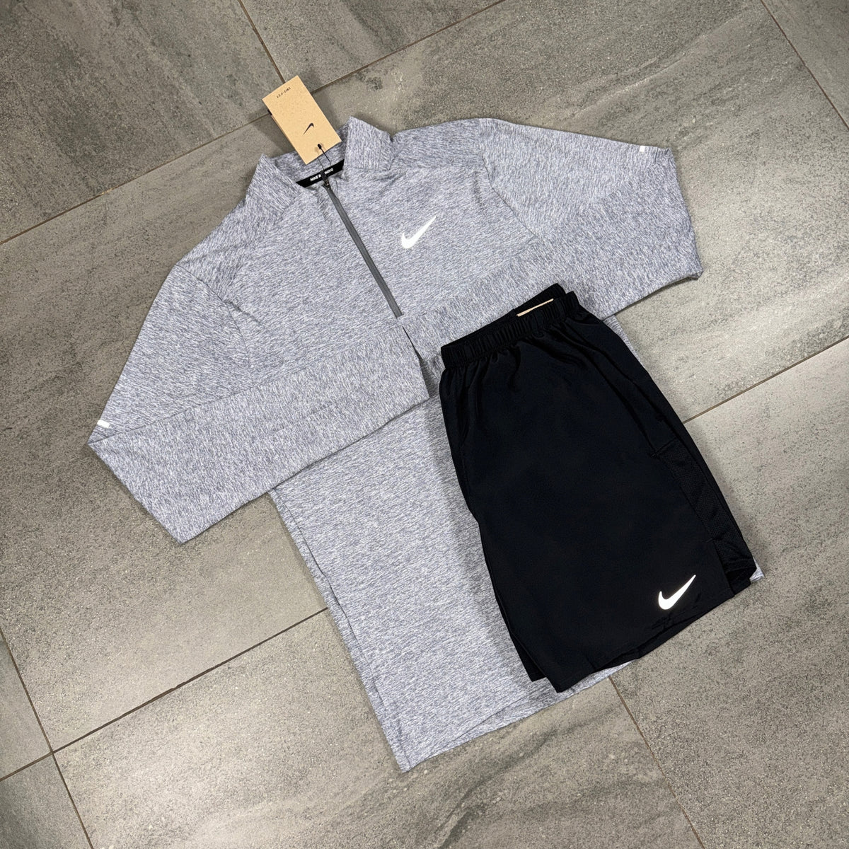 Nike Element Grey Running Top with Black Challenger Shorts flat lay