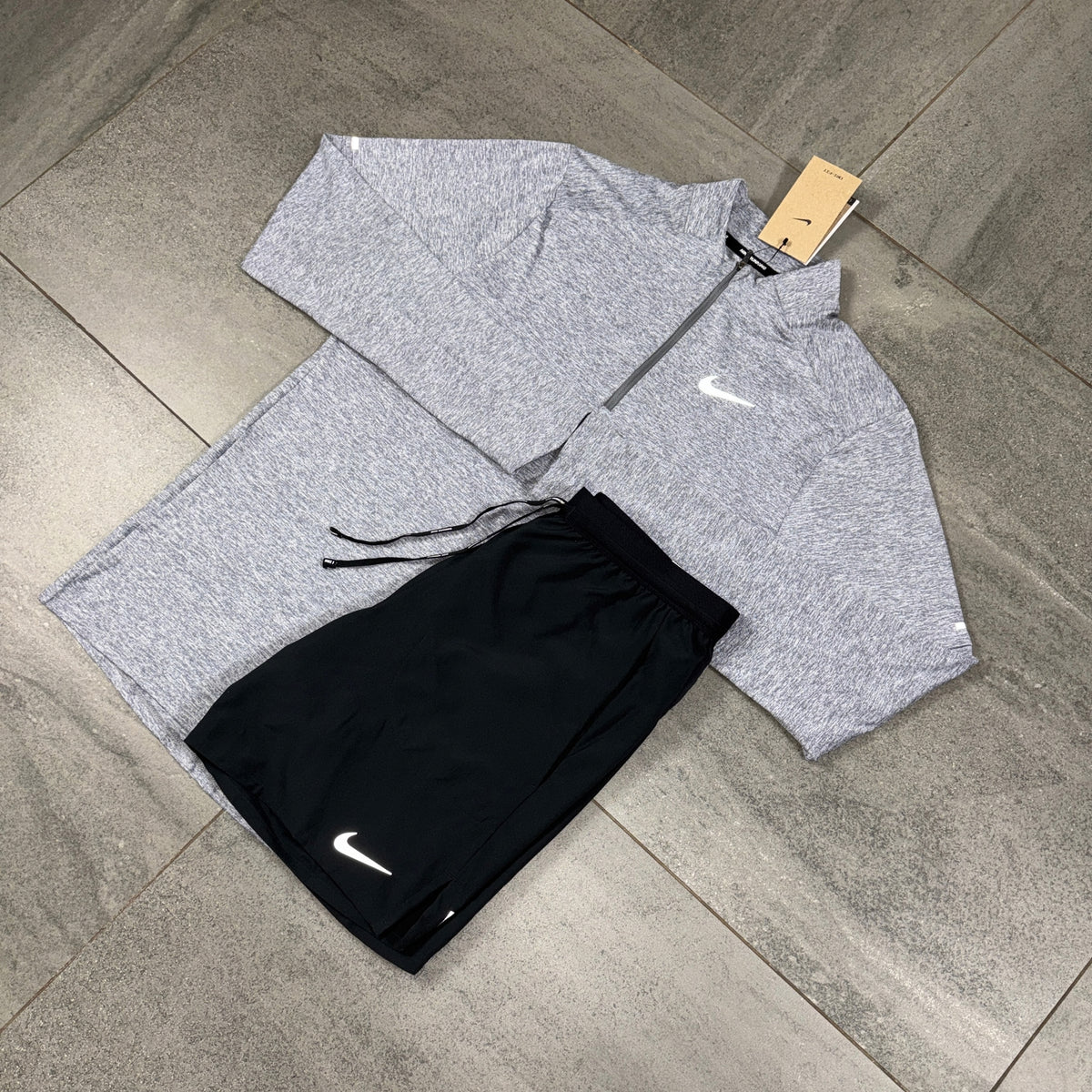 Nike Element Grey Running Top and Black Flex Shorts flat lay