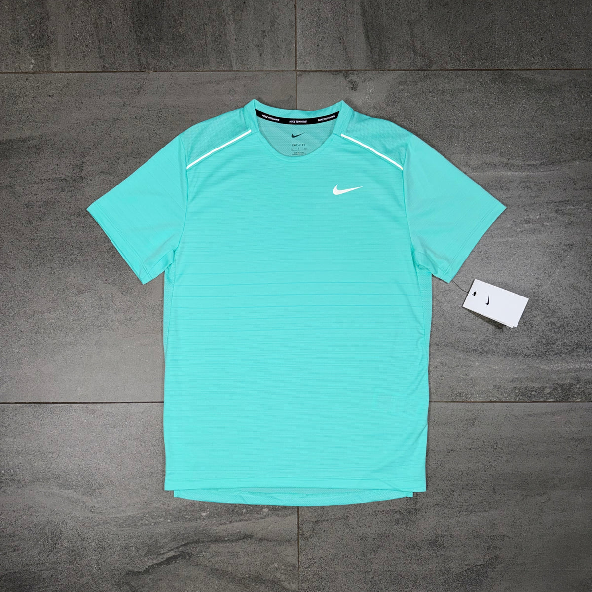 Nike Miler 1.0 Hyper Turquoise running T-shirt laid flat showing the front Swoosh detailing