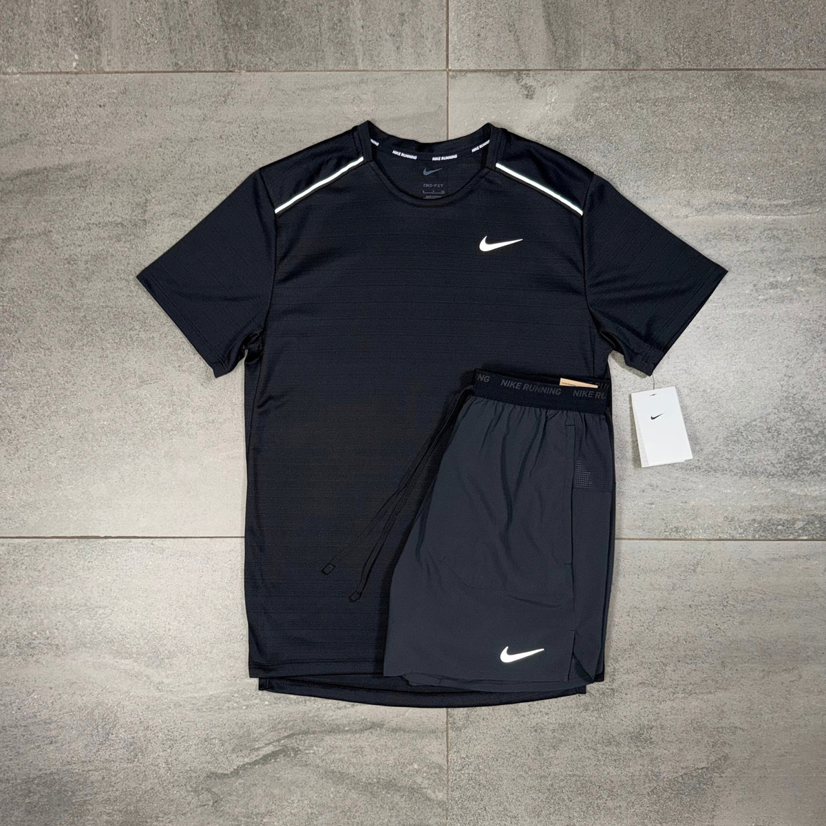 Two-piece Nike sportswear set in black with Miler short-sleeve top and Flex Stride bottoms