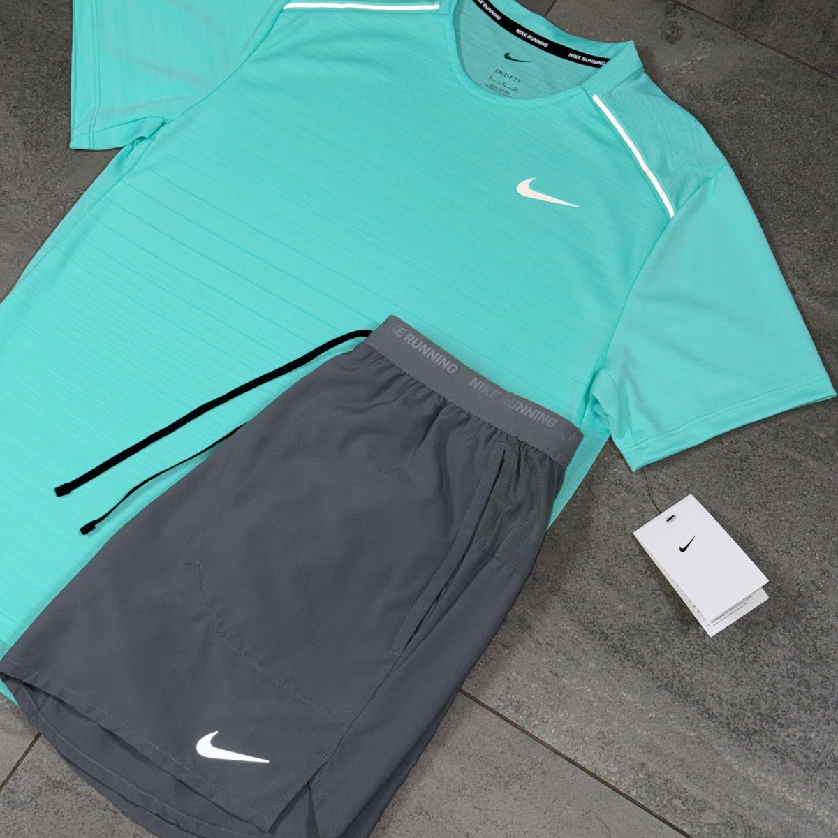 Nike Flex Stride grey shorts displayed beside a Hyper Turquoise Miler T-shirt for a contrasting gym outfit