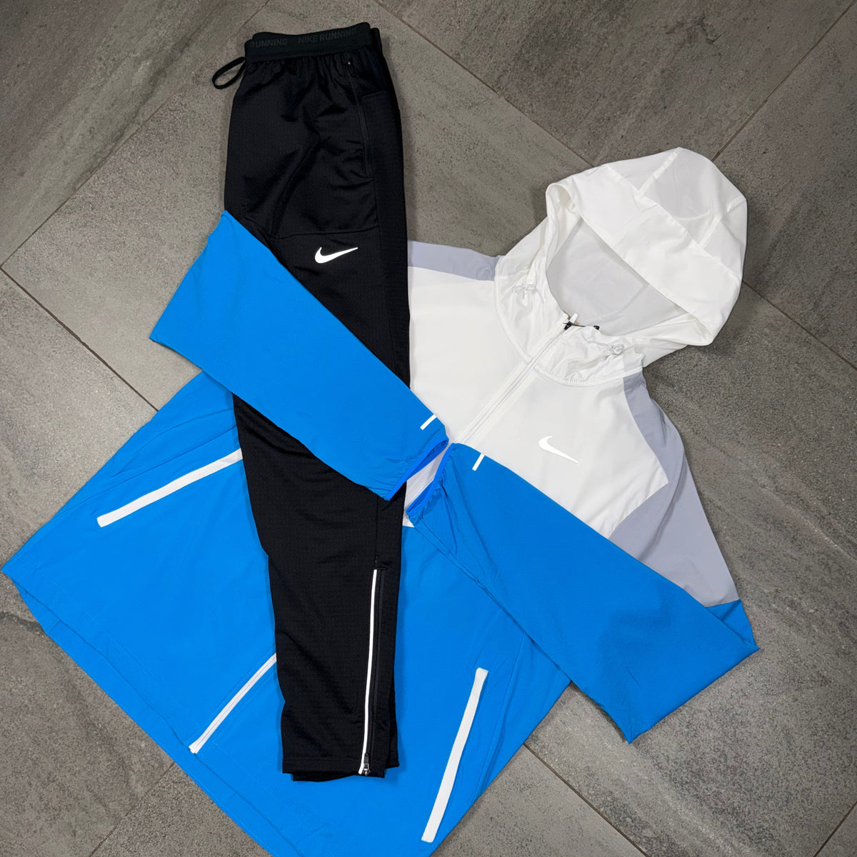 Black Nike Phenom running pants arranged with the colour-block Windrunner jacket