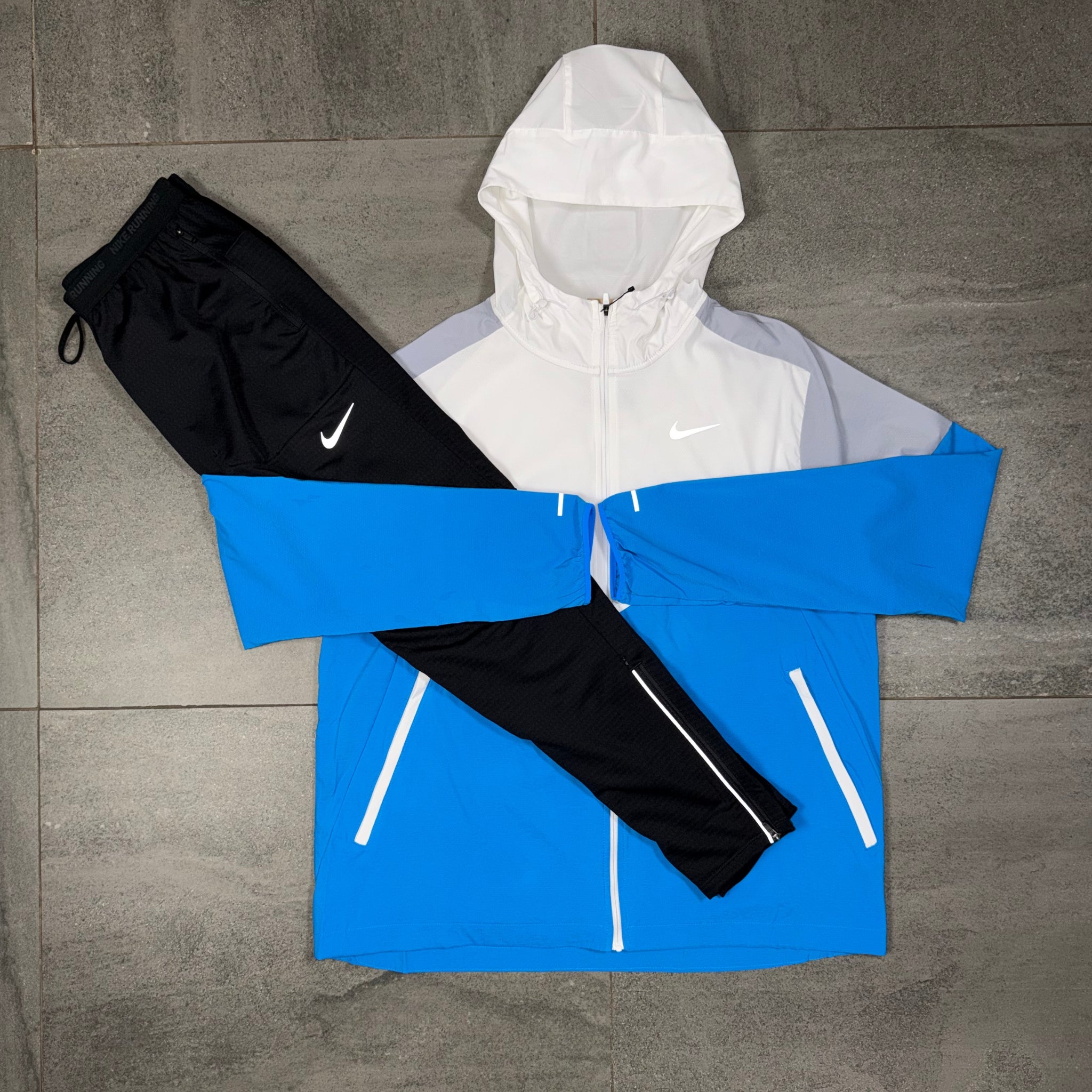 Nike Phenom black pants displayed with the White Wolf Grey Windrunner as a complete tracksuit