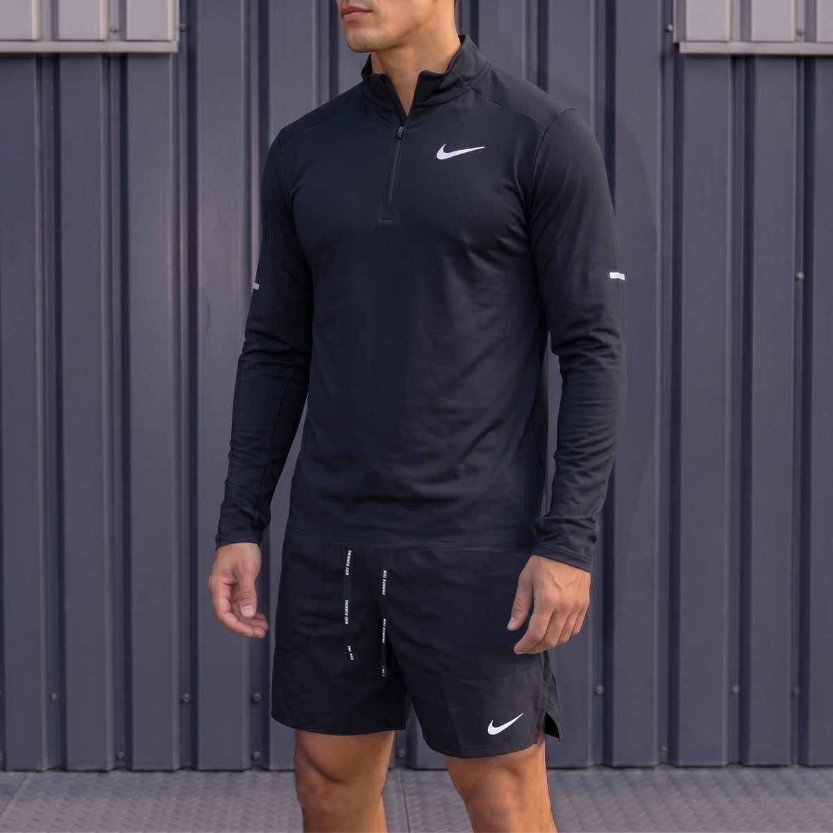Nike 1/4 Running Top and Flex Shorts Element Black set worn by model