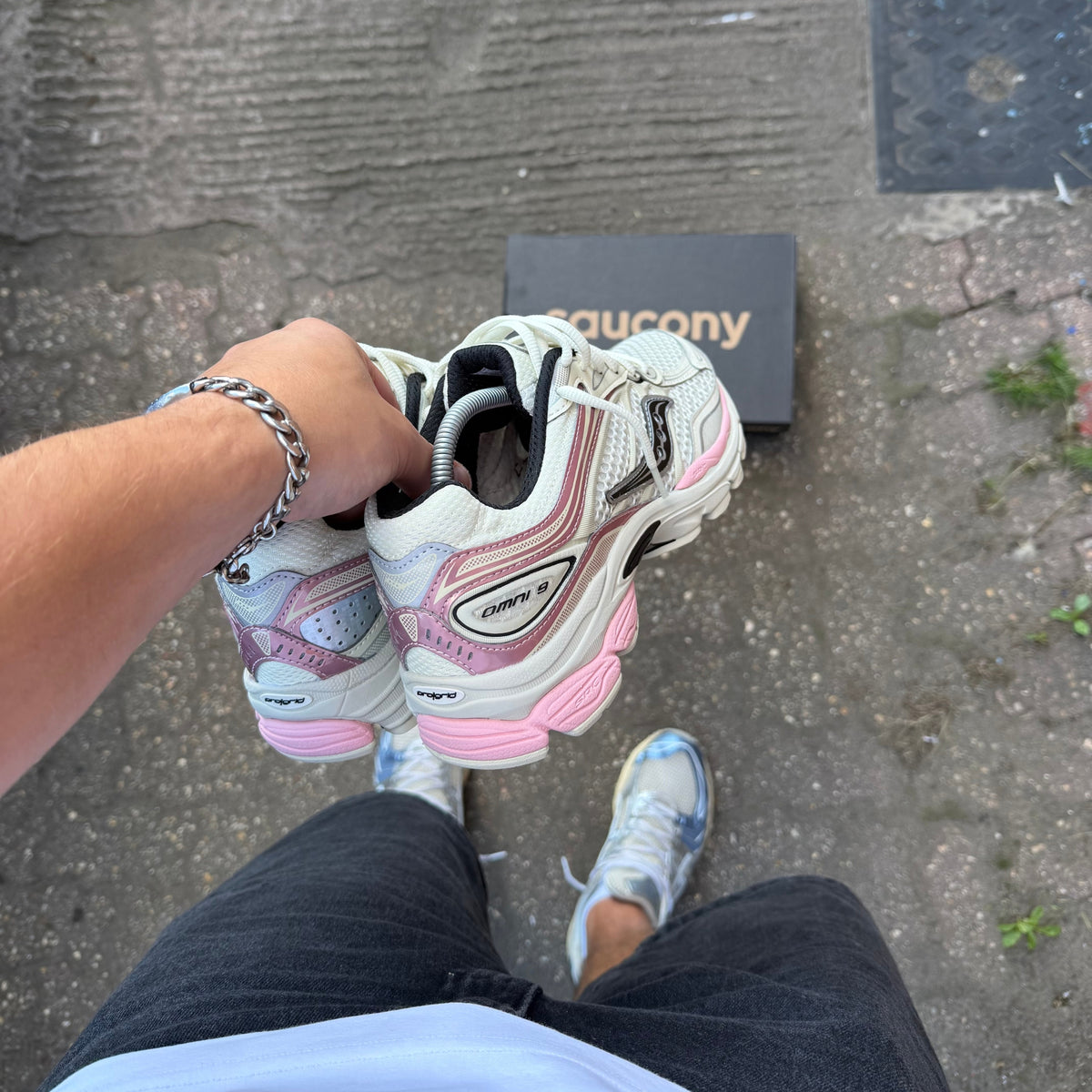 Saucony Eggshell Omni 9 held outdoors showing the rear profile and sculpted pink cushioning