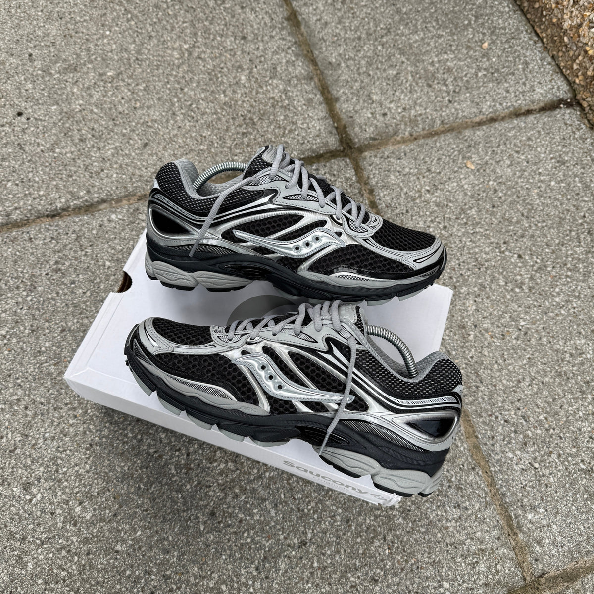 Pair of Saucony ProGrid Omni 9 Black Silver trainers