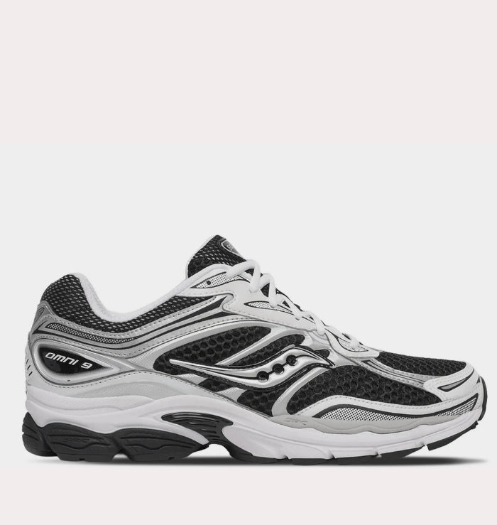 Studio side profile of Saucony ProGrid Omni 9 Black White displaying the full technical silhouette