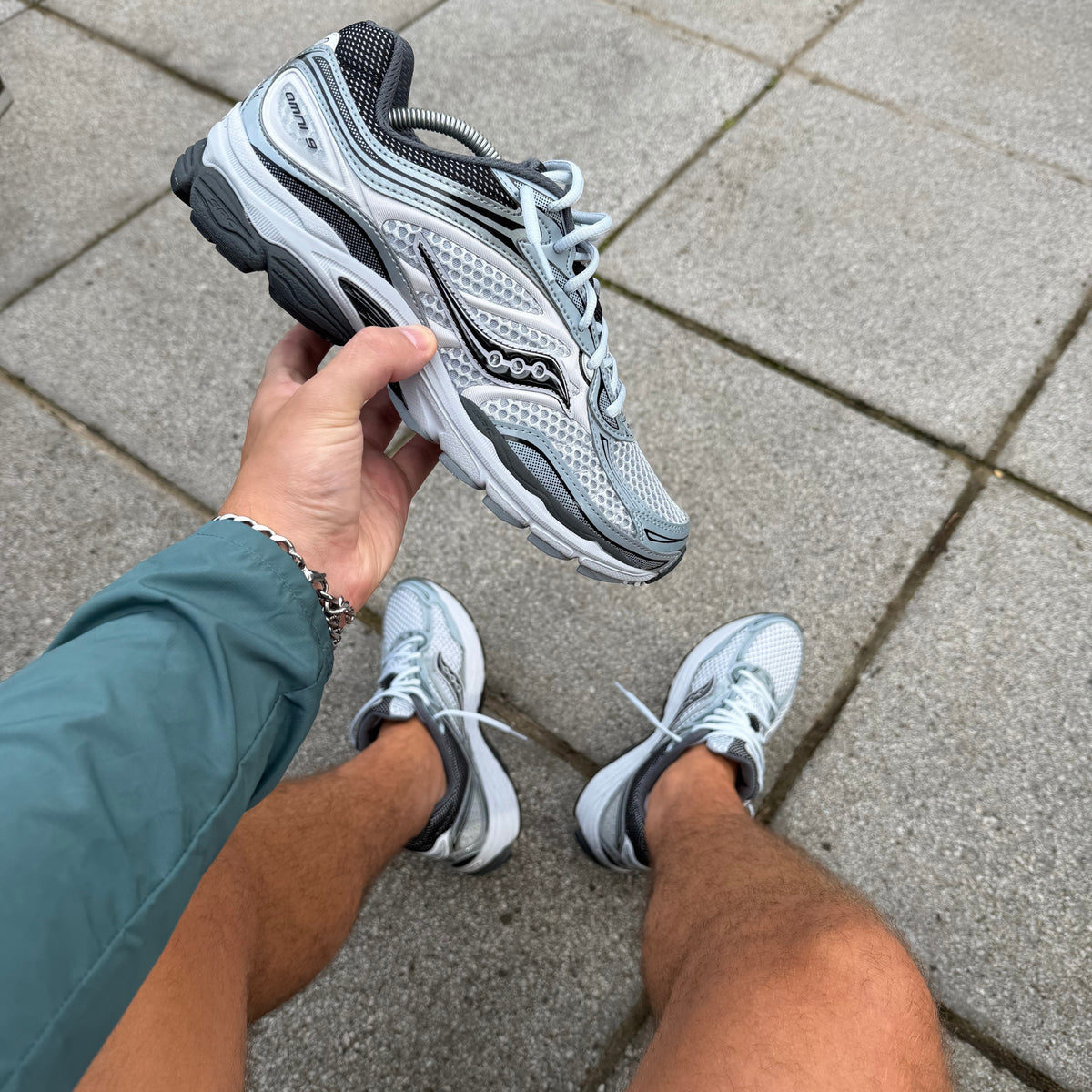 Hand-held view of Saucony ProGrid Omni 9 Microchip trainers
