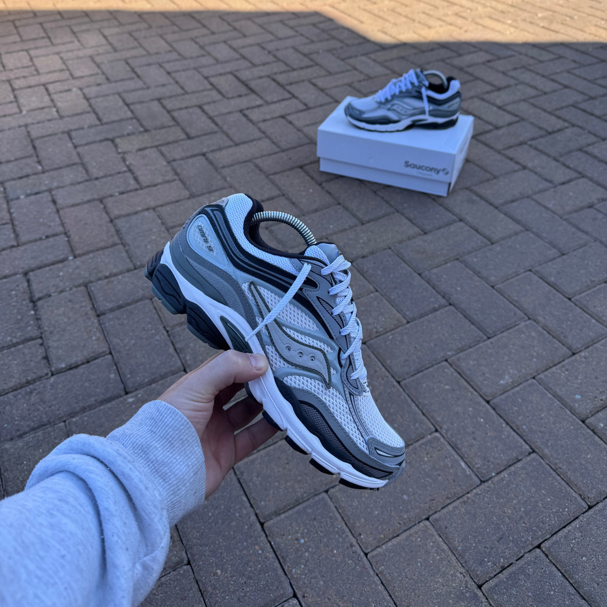 Saucony ProGrid Omni 9 White Grey trainer on foot
