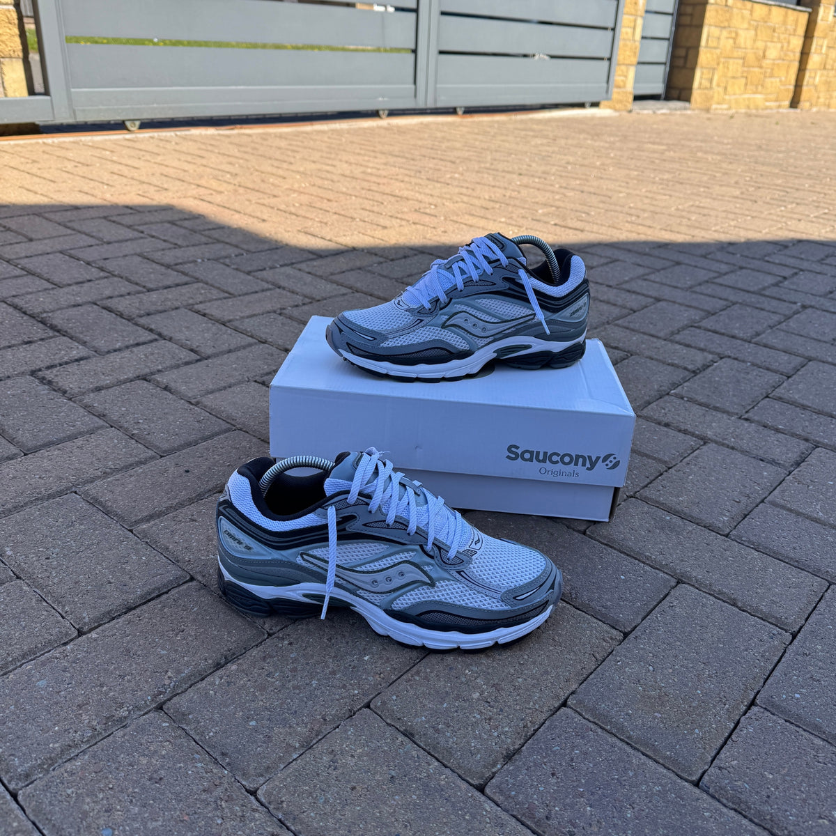 Pair of Saucony ProGrid Omni 9 White Grey trainers