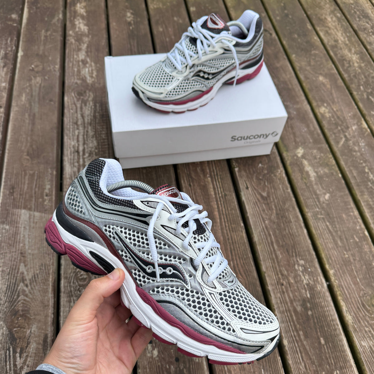 Side view of Saucony ProGrid Omni 9 White Silver Red trainers