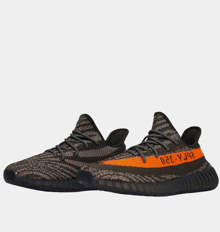 Adidas Yeezy Boost 350 V2 'Carbon Beluga' shoe featuring a dark grey Primeknit upper with black lines and orange speckles, a matching orange stripe with 'SPLY-350' branding on the lateral side, and a ribbed TPU cage on the midsole.