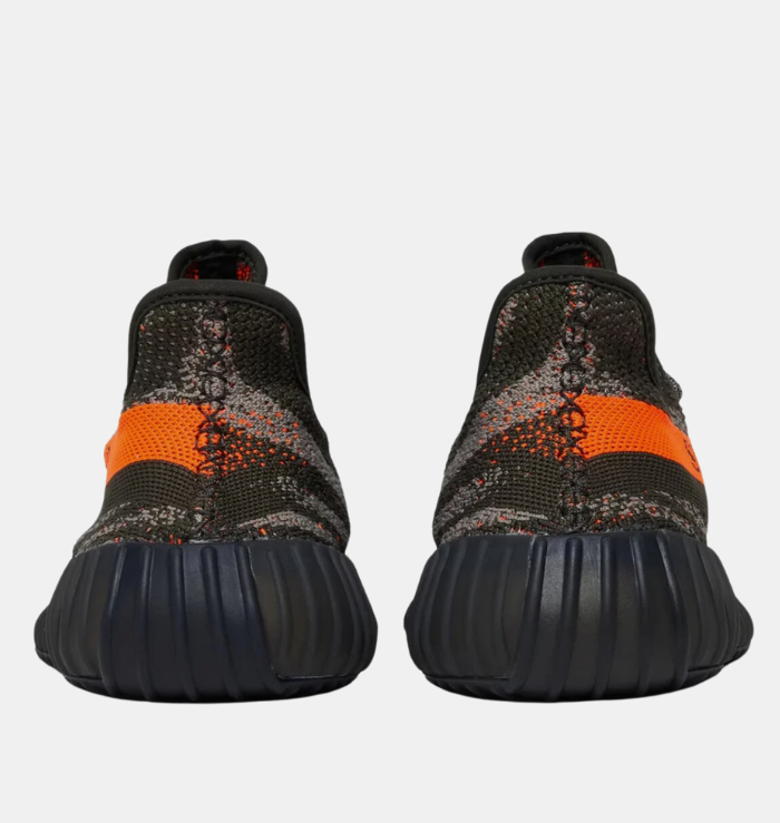 Adidas Yeezy Boost 350 V2 'Carbon Beluga' shoe featuring a dark grey Primeknit upper with black lines and orange speckles, a matching orange stripe with 'SPLY-350' branding on the lateral side, and a ribbed TPU cage on the midsole.
