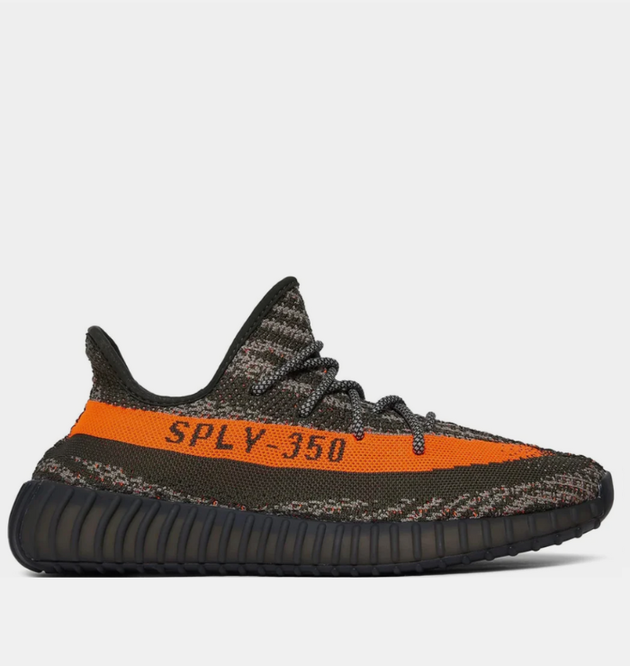 Adidas Yeezy Boost 350 V2 'Carbon Beluga' shoe featuring a dark grey Primeknit upper with black lines and orange speckles, a matching orange stripe with 'SPLY-350' branding on the lateral side, and a ribbed TPU cage on the midsole.
