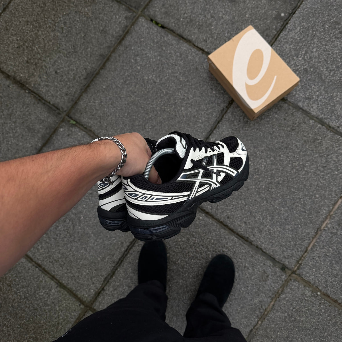 ASICS GEL-1130 Black Cream trainer viewed from above showing black and cream layered upper and white laces