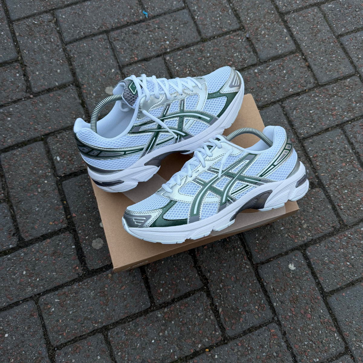 Pair of white and Forest Night green ASICS Gel-1130 trainers