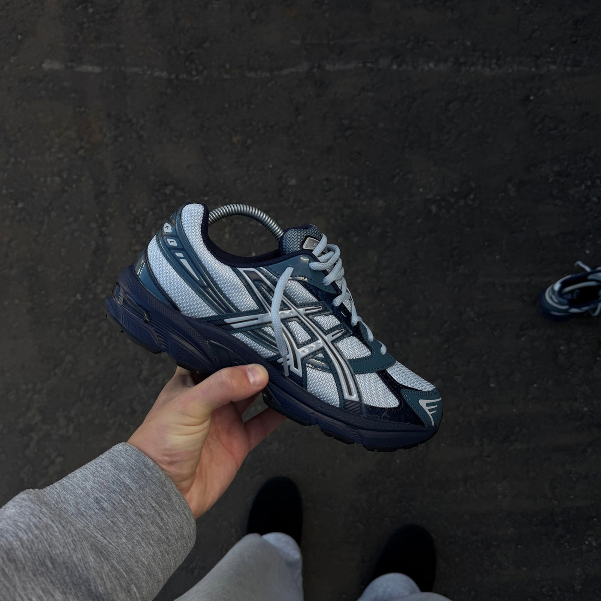 ASICS Gel-1130 Piedmont Blue trainer shown from the side highlighting the layered blue and grey upper