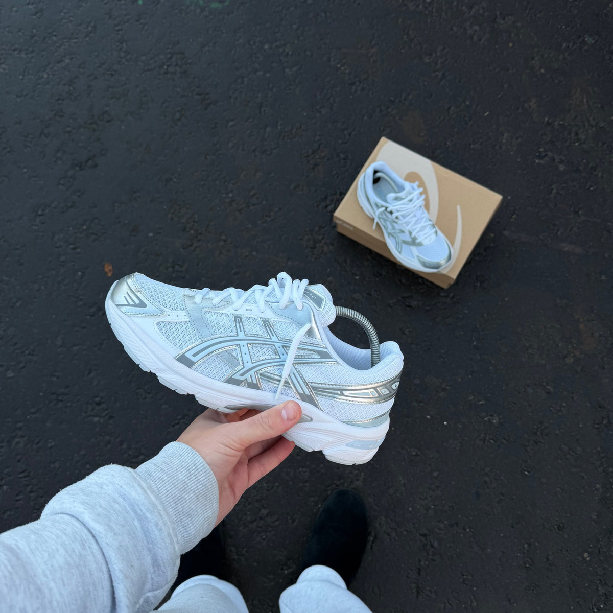 Side profile of ASICS GEL-1130 White Storm Cloud trainer highlighting silver ASICS branding and cushioned midsole