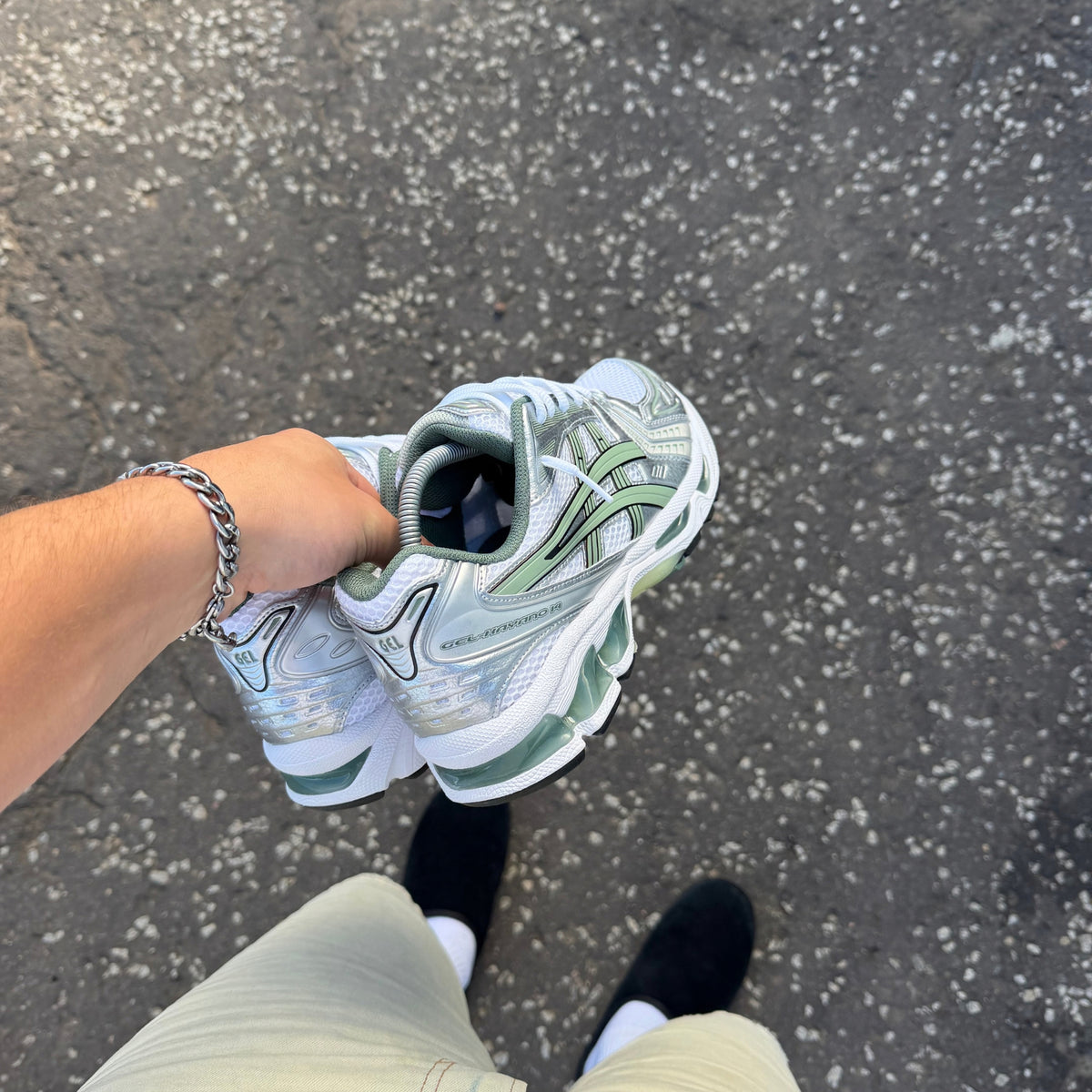 Hand-held view of ASICS Gel-Kayano 14 Slate Grey trainer