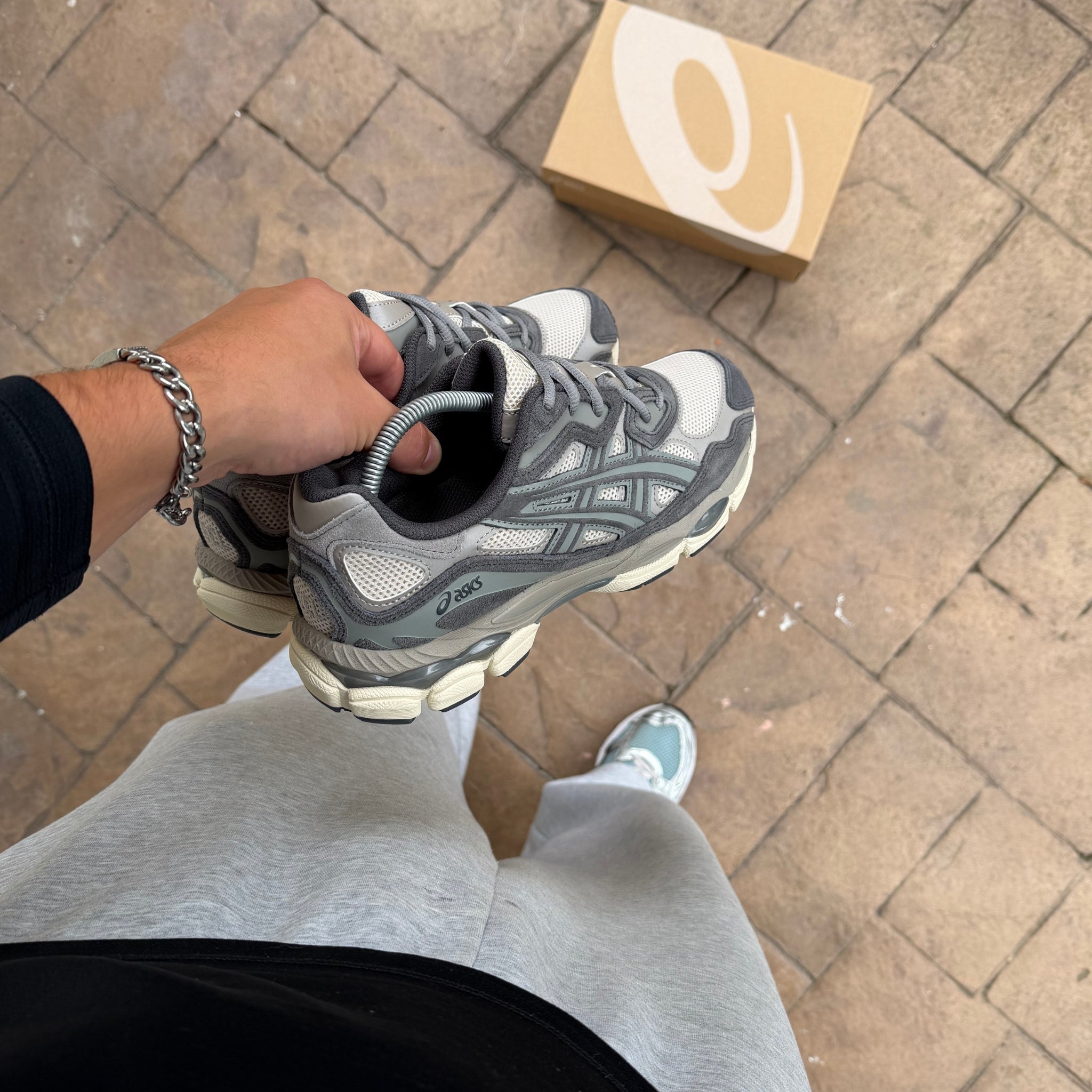 ASICS Gel-NYC Oatmeal Obsidian trainer held in hand