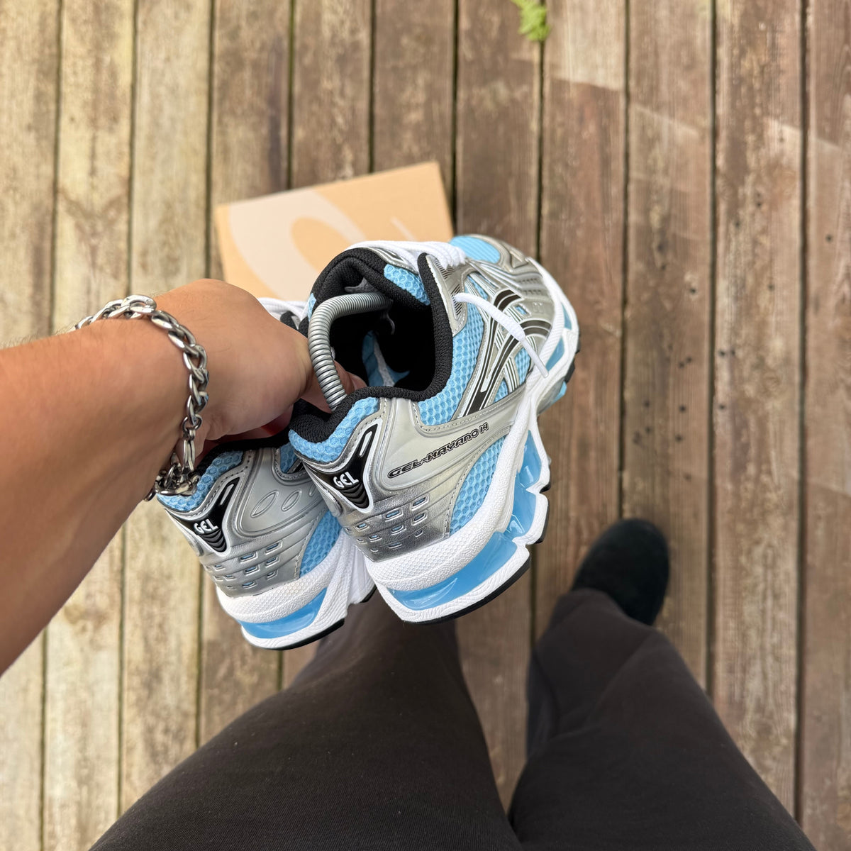 ASICS Kayano Arctic Sky Pure Silver rear view showing the heel structure and blue cushioning accents