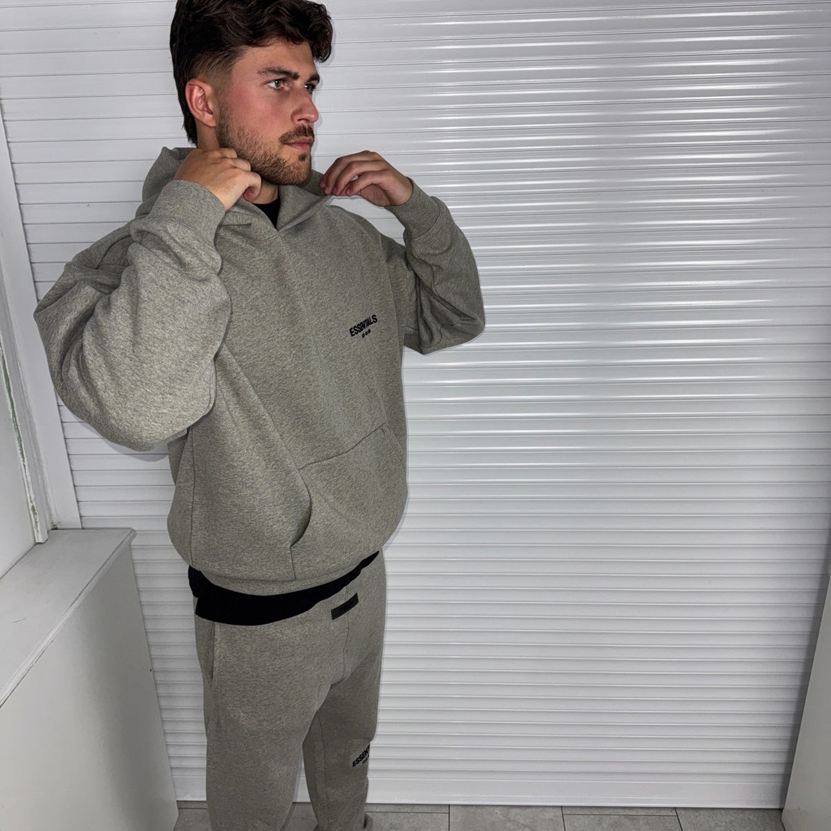 Fear of God Essentials Dark Heather Oatmeal Hoodie model view showing the hood and relaxed styling