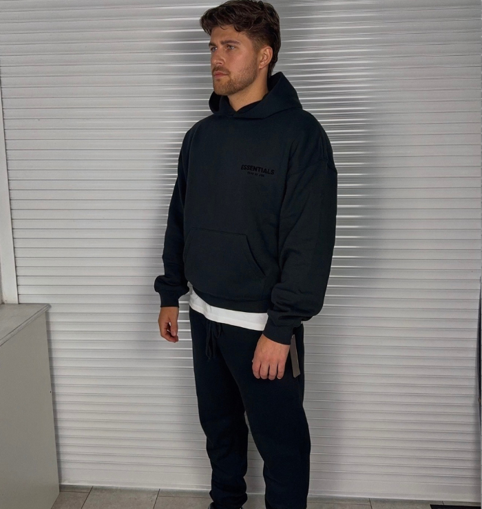 Fear of God Essentials Black Hoodie SS22 worn from the front showing the relaxed oversized fit