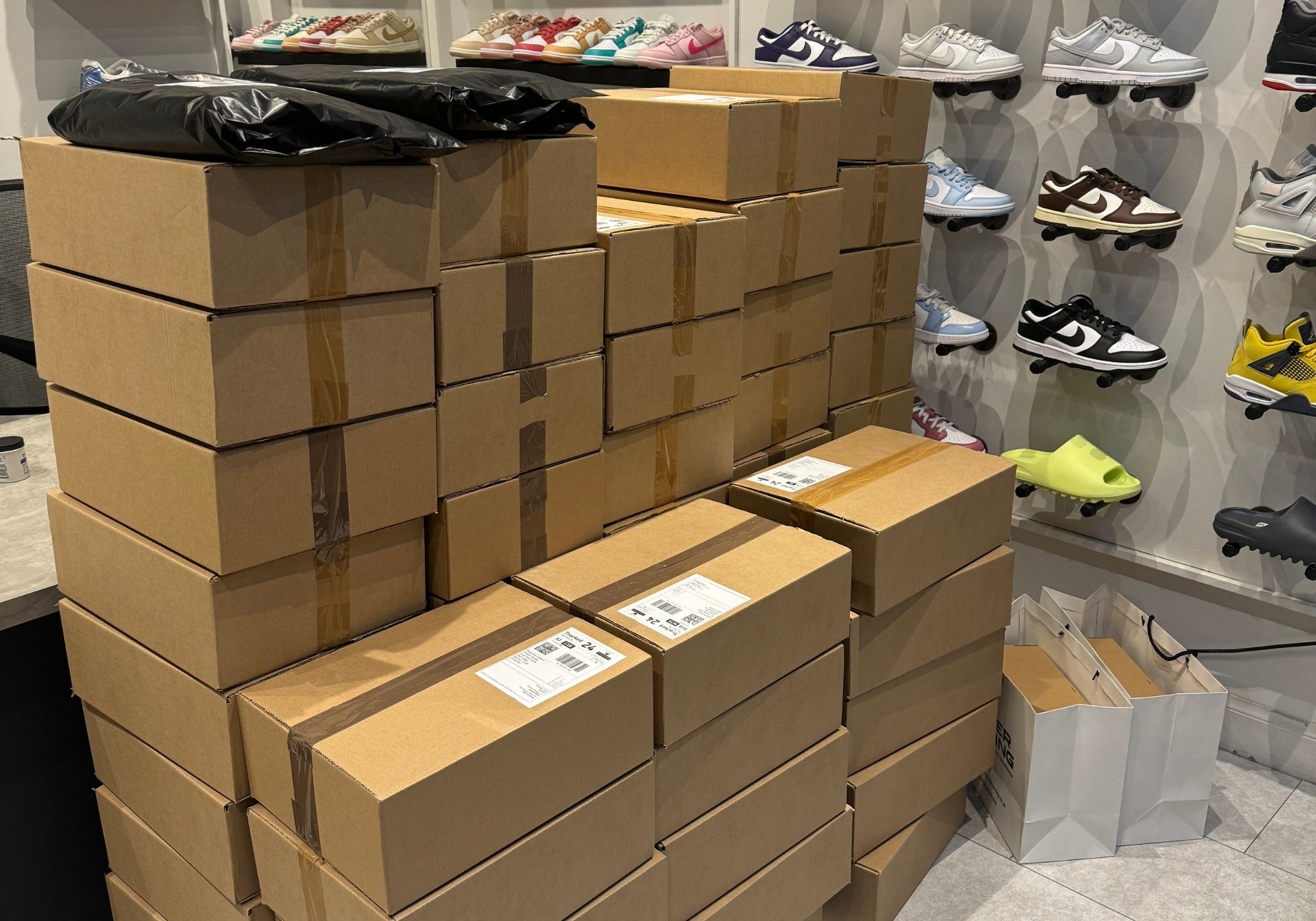 Forever Sourcing store with boxed stock and trainers on display