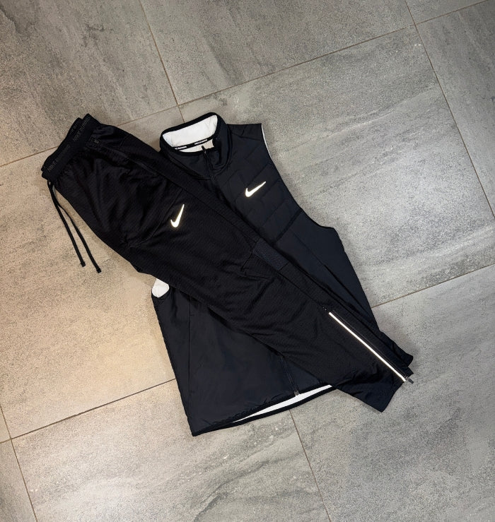 Black Nike AeroLayer Gilet and Phenom Pants flat lay