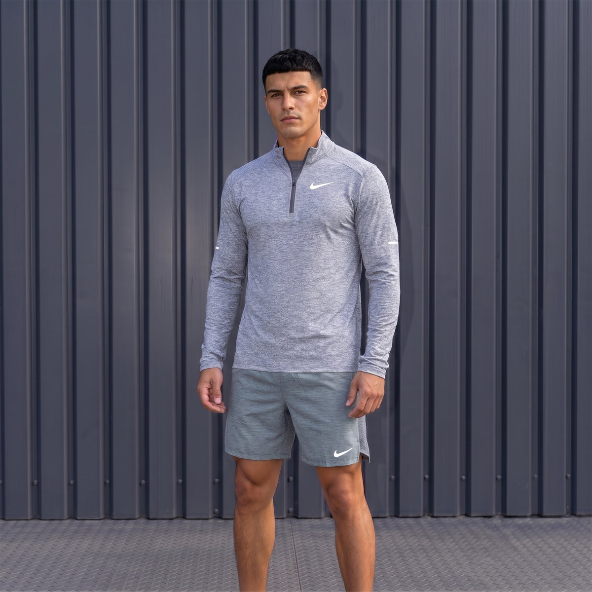 Nike Element Grey quarter zip running top worn with black shorts
