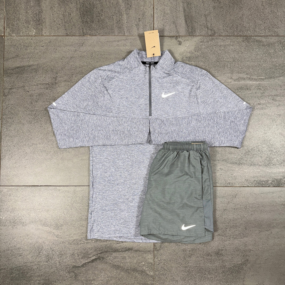 Nike Grey 1/4 Zip Running Top and Challenger Shorts flat lay