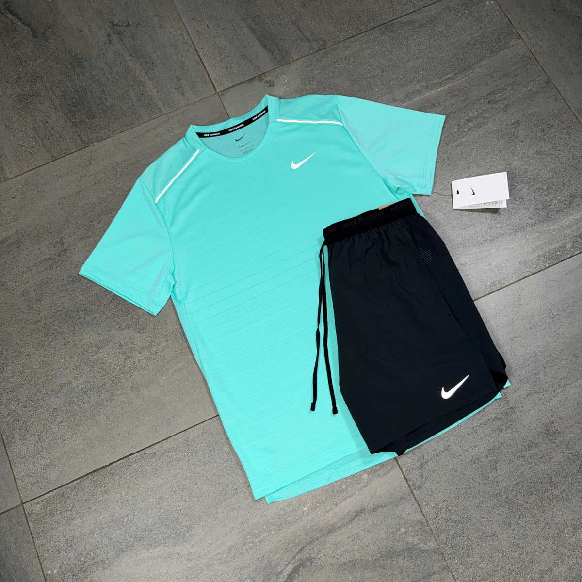 Hyper Turquoise Nike Miler running top paired with black Nike Flex Stride shorts