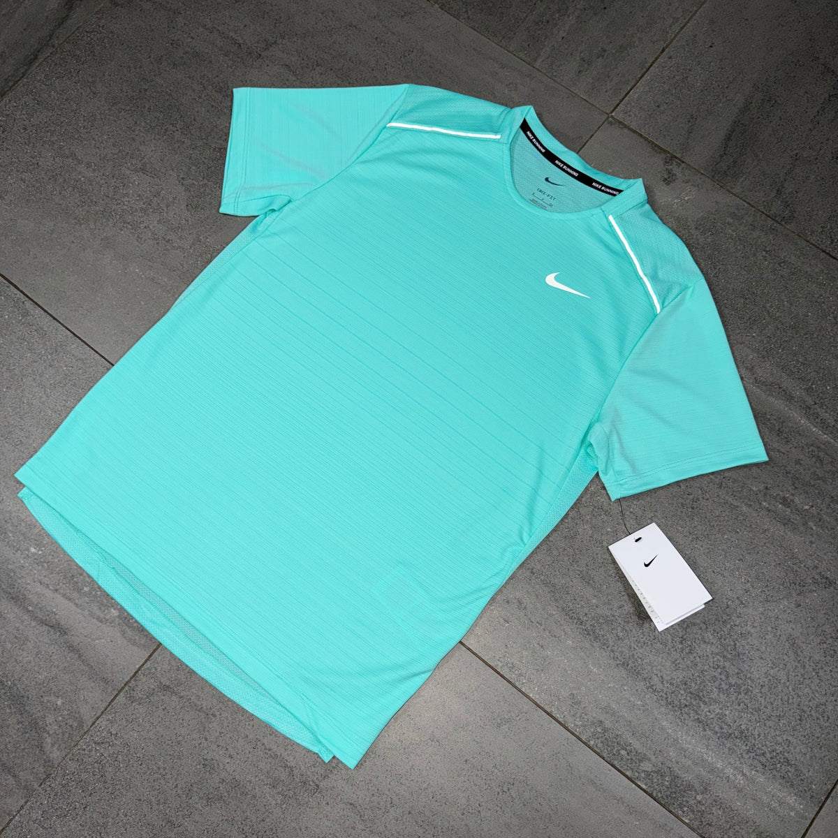 Turquoise Nike Miler 1.0 training T-shirt displayed flat with short sleeves visible