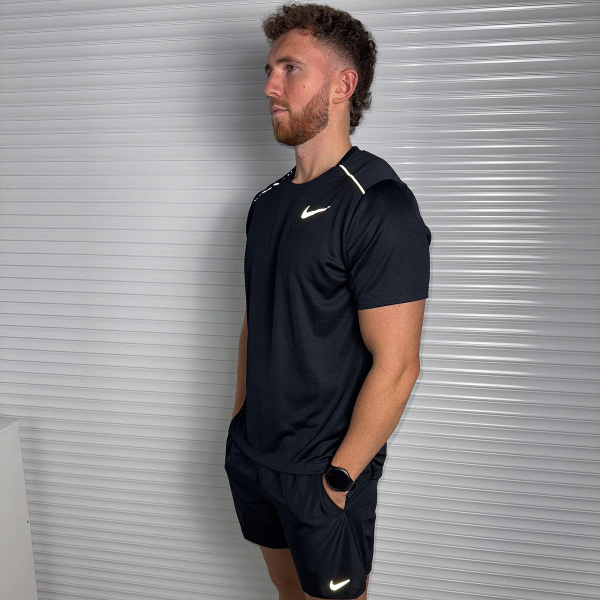 Full-length view of Nike Miler 1.0 Black running top worn with matching black activewear shorts