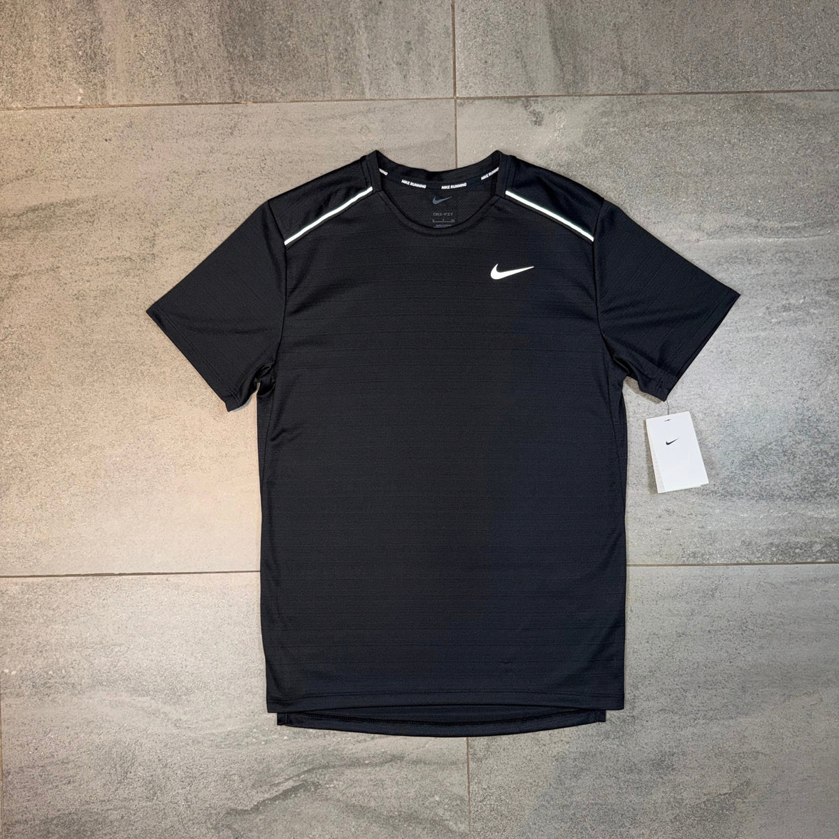 Nike Miler 1.0 Black T-Shirt worn by a model showing the athletic fit and white Nike Swoosh