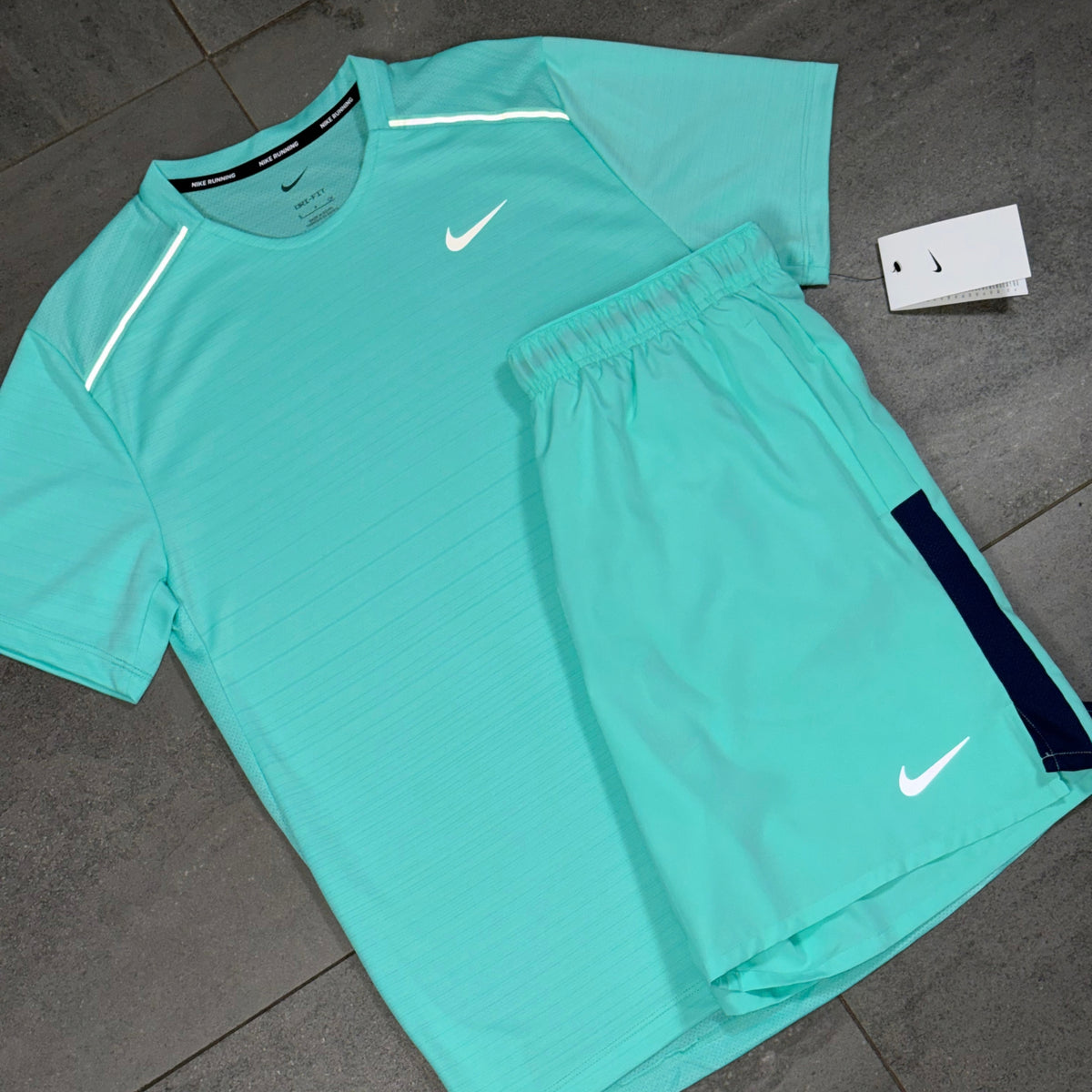 Turquoise Nike Dri-FIT Miler and Challenger training set showing contrasting dark side panels