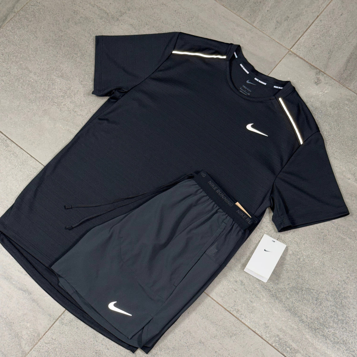 Angled view of the black Nike Miler performance top and Flex Stride running shorts