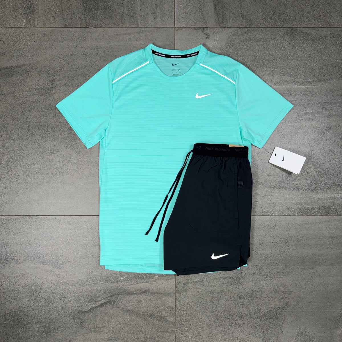 Nike Miler T-Shirt and Flex Stride Shorts set in Hyper Turquoise and Black laid flat together