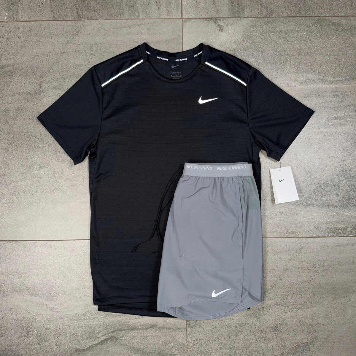 Nike Miler and Flex Stride two-piece training set displayed with black running top and grey shorts